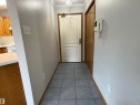 Foyer with grey tile flooring, white walls, and a recessed ceiling light fixture - 309 10610 76 Street, Edmonton, AB  - Indoor 