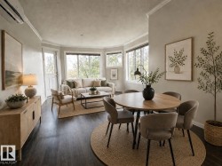 Open-concept living area featuring dark wood-finish flooring and crown molding - 
