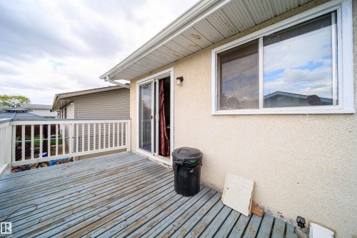 Spacious outdoor deck with white railing, featuring direct access via sliding glass doors and a large window - 1771 37 Street, Edmonton, AB - Outdoor With Deck Patio Veranda With Exterior