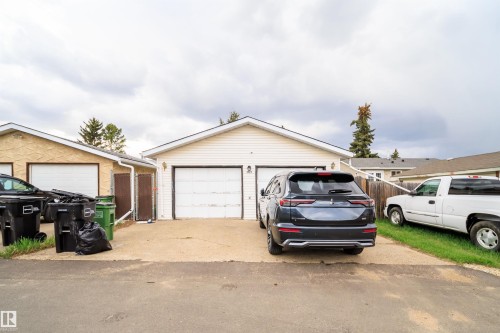 Two-car detached garage with white panel doors and light-colored siding - 1771 37 Street, Edmonton, AB - Outdoor