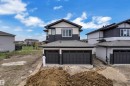 Contemporary exterior featuring a two-tone facade with dark siding and light-colored panels - 12623 44 Street, Edmonton, AB 