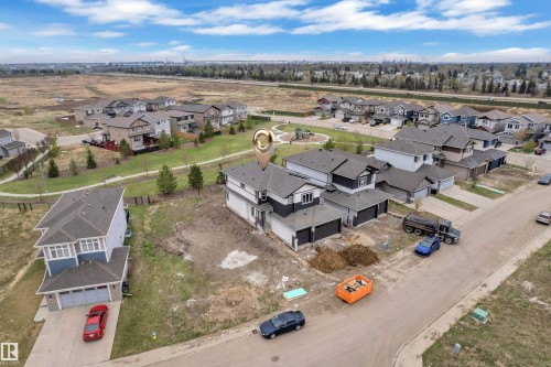 Newly constructed residence featuring a two-story design with a two-car garage and dark roofing - 12623 44 Street, Edmonton, AB 