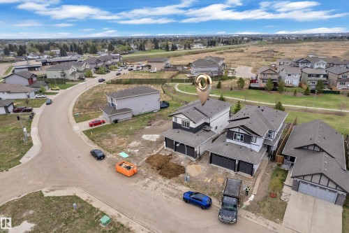 Modern two-story residence with a multi-car garage, dark trim accents, and a light-colored exterior siding - 12623 44 Street, Edmonton, AB 