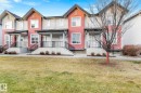 Townhouse exterior featuring a combination of horizontal siding and shake siding accents - 30 6075 Schonsee Way, Edmonton, AB  - Outdoor With Deck Patio Veranda With Facade 