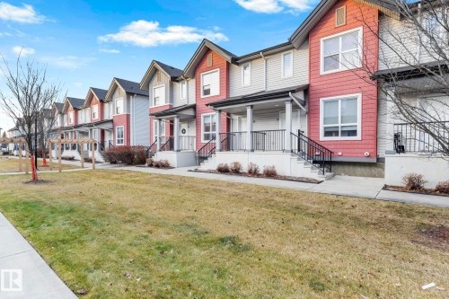 Exterior featuring multi-toned siding, gabled rooflines, and covered front entrances - 30 6075 Schonsee Way, Edmonton, AB - Outdoor With Deck Patio Veranda With Facade