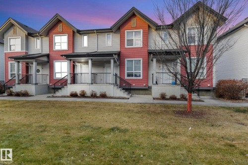Townhome exterior featuring horizontal siding and red shake accents - 30 6075 Schonsee Way, Edmonton, AB - Outdoor With Deck Patio Veranda With Facade