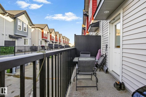 Private balcony patio featuring concrete flooring and a dark metal railing - 30 6075 Schonsee Way, Edmonton, AB - Outdoor With Exterior