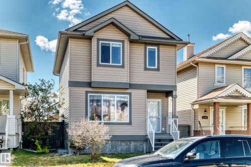 Two-story residential structure featuring light beige siding with dark gray trim accents - 2339 28B Ave Avenue, Edmonton, AB - Outdoor