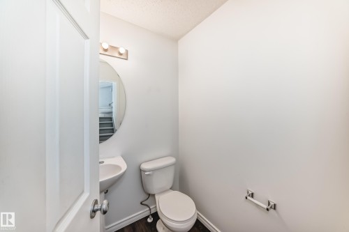White painted walls with dark wood-finish flooring - 2339 28B Ave Avenue, Edmonton, AB - Indoor Photo Showing Bathroom