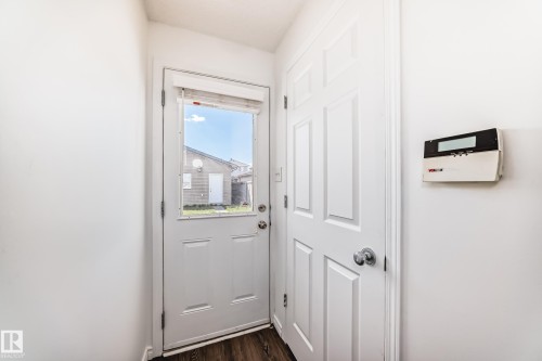 White paneled door with an upper window providing exterior light - 2339 28B Ave Avenue, Edmonton, AB - Indoor Photo Showing Other Room