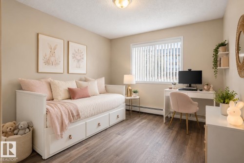 Room featuring wood-finish flooring, a window with vertical blinds, and a built-in daybed with integrated storage drawers - 110 2903 Rabbit Hill Road, Edmonton, AB - Indoor Photo Showing Bedroom