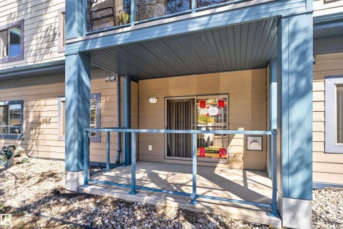 Covered concrete patio with glass railing and durable siding exterior - 110 2903 Rabbit Hill Road, Edmonton, AB - Outdoor With Exterior