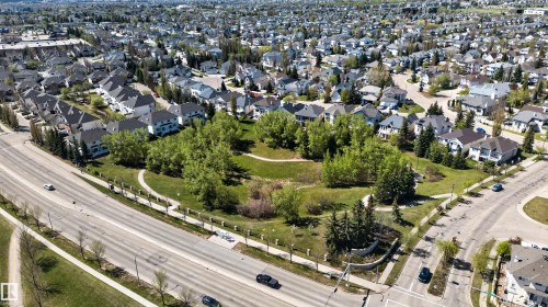 Aerial perspective showcasing a residential area with a prominent green space - 110 2903 Rabbit Hill Road, Edmonton, AB - Outdoor With View