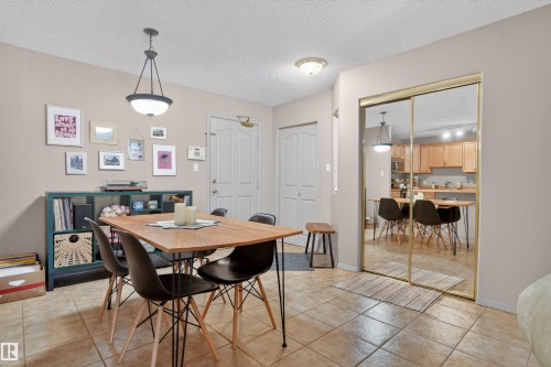 Dining area featuring light beige walls, a tiled floor, and a modern ceiling light fixture - 110 2903 Rabbit Hill Road, Edmonton, AB - Indoor Photo Showing Dining Room