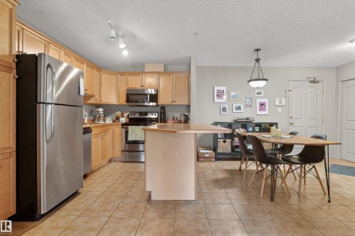 Open-concept kitchen and dining area featuring tile flooring - 110 2903 Rabbit Hill Road, Edmonton, AB - Indoor Photo Showing Kitchen
