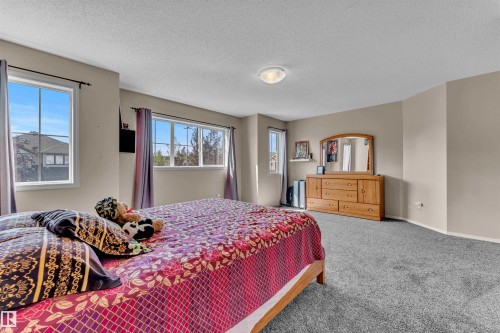 Bedroom featuring a textured ceiling and carpet - 6152 13 Avenue, Edmonton, AB - Indoor Photo Showing Bedroom