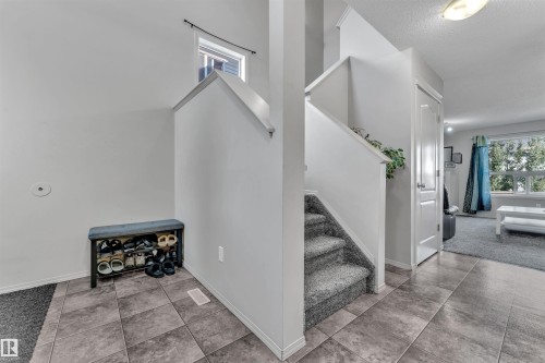 Stairs with tile patterned flooring and a textured ceiling - 6152 13 Avenue, Edmonton, AB - Indoor Photo Showing Other Room