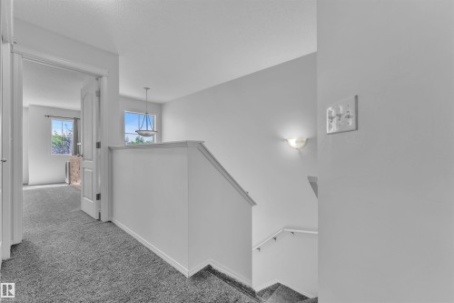 Corridor featuring carpet floors and an upstairs landing - 6152 13 Avenue, Edmonton, AB - Indoor Photo Showing Other Room