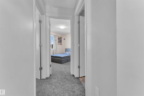 Hall featuring light carpet and a textured ceiling - 6152 13 Avenue, Edmonton, AB - Indoor Photo Showing Other Room