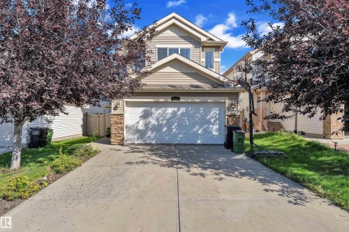 Traditional-style house with stone siding and concrete driveway - 6152 13 Avenue, Edmonton, AB - Outdoor