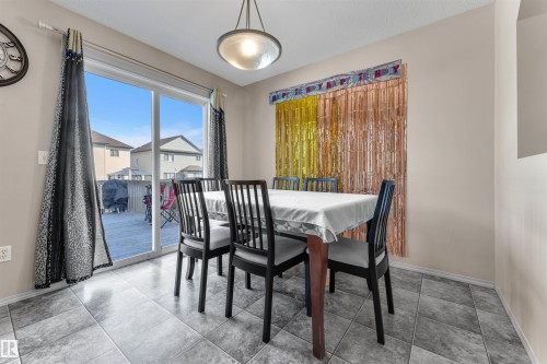 Dining space featuring light tile patterned floors - 6152 13 Avenue, Edmonton, AB - Indoor Photo Showing Dining Room