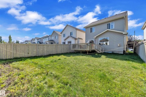 Fenced backyard with a deck and a residential view - 6152 13 Avenue, Edmonton, AB - Outdoor With Deck Patio Veranda