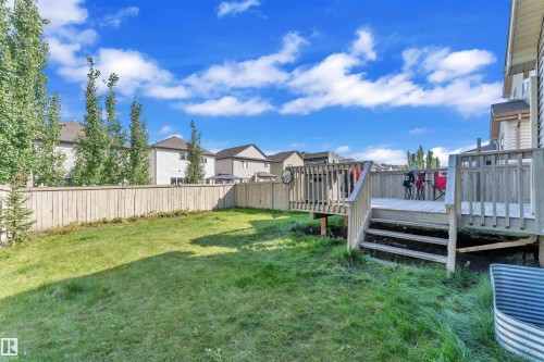Fenced backyard featuring a deck and a residential view - 6152 13 Avenue, Edmonton, AB - Outdoor