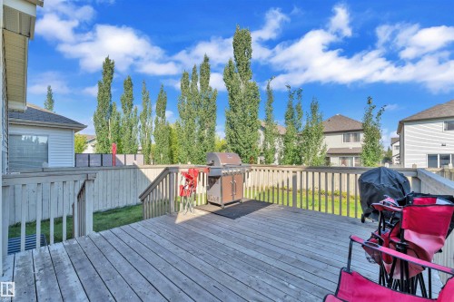 Wooden terrace with grilling area, a fenced backyard, and a residential view - 6152 13 Avenue, Edmonton, AB - Outdoor With Deck Patio Veranda With Exterior