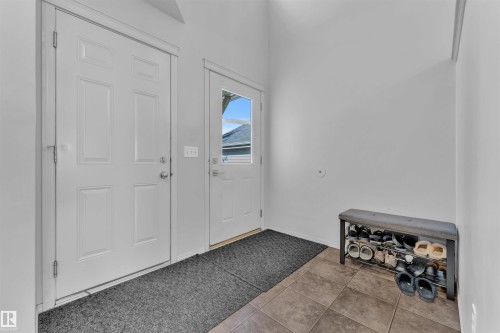 Entrance foyer with tile patterned floors and baseboards - 6152 13 Avenue, Edmonton, AB - Indoor Photo Showing Other Room