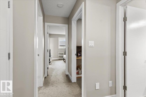Hallway featuring light neutral wall paint, white trim, recessed ceiling lighting, and carpet flooring - 236 39 Avenue, Edmonton, AB - Indoor Photo Showing Other Room