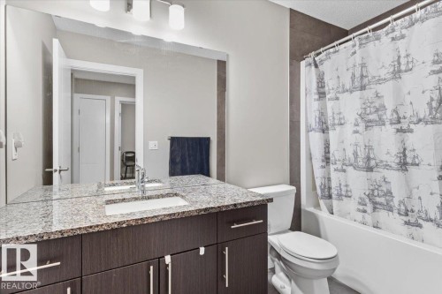 Bathroom featuring a dark wood-finish vanity with a granite countertop and an integrated sink - 236 39 Avenue, Edmonton, AB - Indoor Photo Showing Bathroom
