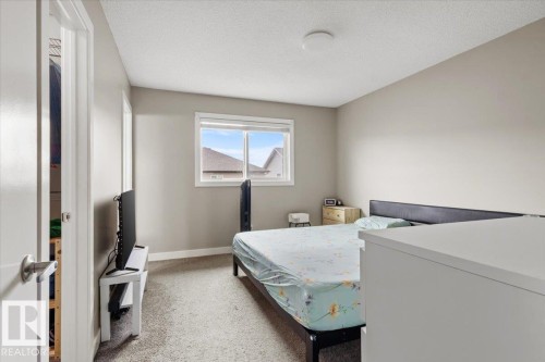 Carpeted bedroom with a window featuring white trim - 236 39 Avenue, Edmonton, AB - Indoor Photo Showing Bedroom
