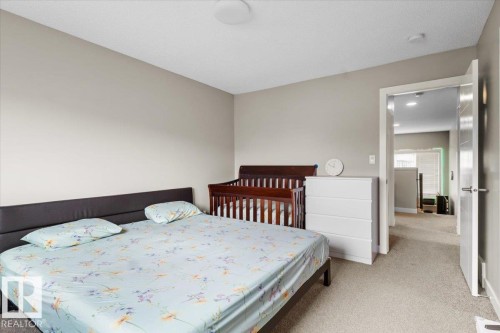 Carpeted bedroom with neutral wall tones and a ceiling-mounted light fixture - 236 39 Avenue, Edmonton, AB - Indoor Photo Showing Bedroom