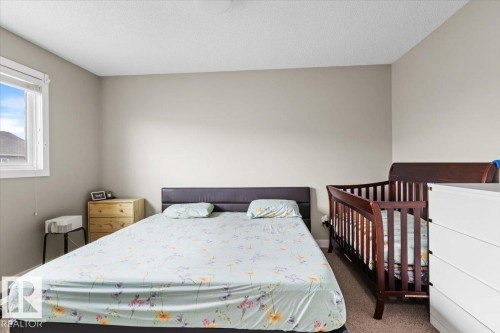 Bedroom with neutral wall paint, carpet flooring, and a window with white trim - 236 39 Avenue, Edmonton, AB - Indoor Photo Showing Bedroom