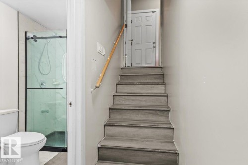 Staircase with wood-finish treads and a light wood handrail - 236 39 Avenue, Edmonton, AB - Indoor