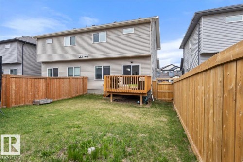 Private backyard featuring a wood deck, full wood fencing, and a grassy area - 236 39 Avenue, Edmonton, AB - Outdoor With Deck Patio Veranda With Exterior