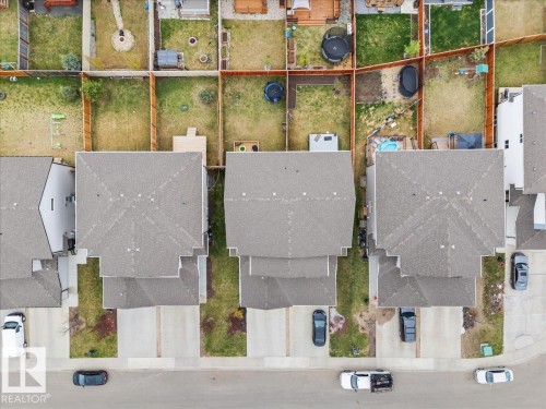 Aerial perspective showcasing three distinct properties, each featuring a pitched roof with grey shingles - 236 39 Avenue, Edmonton, AB - Other