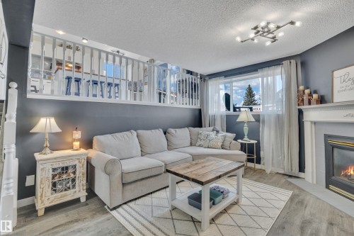 10 Campbell Road, Leduc, AB - Indoor Photo Showing Living Room With Fireplace