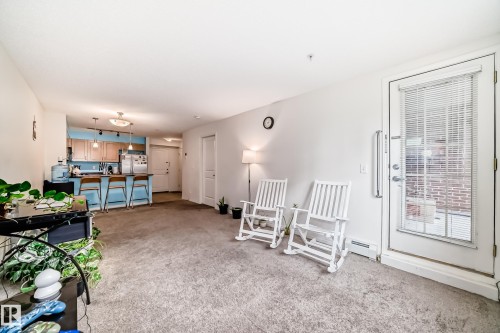 Open concept living space with wall-to-wall carpeting - 113 11441 Ellerslie Road, Edmonton, AB - Indoor