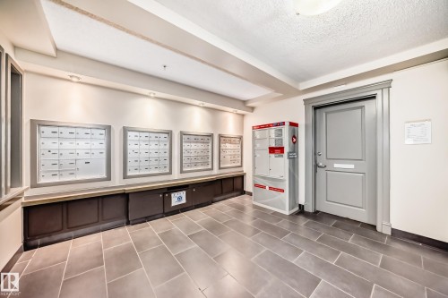 Building common area featuring large format tile flooring and recessed lighting - 113 11441 Ellerslie Road, Edmonton, AB - Indoor Photo Showing Other Room