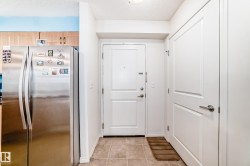 Entryway featuring a white paneled door with brushed nickel hardware, complementing a second white door - 