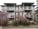 Multi-level exterior featuring brick and siding, multiple balconies with white railings, and arched windows - 2945 26 Street, Edmonton, AB  - Outdoor With Balcony 