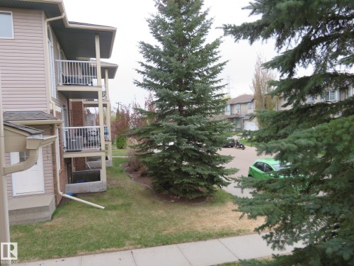 Multi-level residential building featuring tan siding and brick accents - 2945 26 Street, Edmonton, AB - Outdoor With Balcony