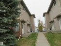 Townhome exterior featuring tan siding and brick accents - 2945 26 Street, Edmonton, AB  - Outdoor 