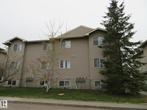Three-story building with tan horizontal siding - 2945 26 Street, Edmonton, AB - Outdoor