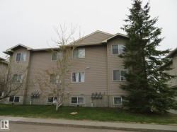 Three-story building with tan horizontal siding - 