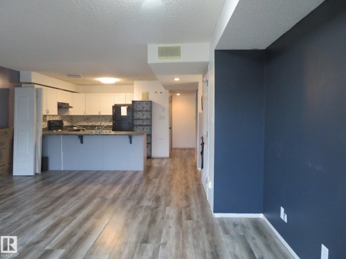 Kitchen featuring white cabinetry, grey countertops, and wood-finish flooring - 2945 26 Street, Edmonton, AB - Indoor Photo Showing Kitchen