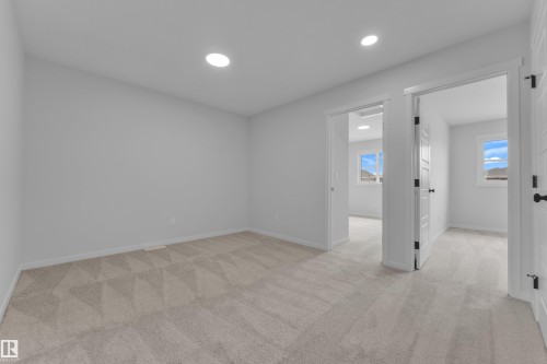 Spacious interior room featuring light-toned carpeting, recessed ceiling lighting, and white trim - 17330 6A Street Ne, Edmonton, AB - Indoor Photo Showing Other Room