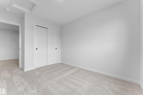 Room featuring light gray carpeting, white walls, and white trim - 17330 6A Street Ne, Edmonton, AB - Indoor Photo Showing Other Room