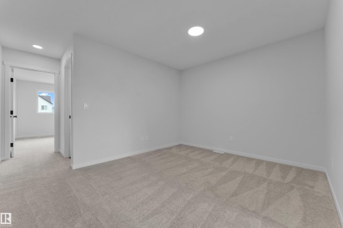 Neutral-toned carpet flooring extends throughout this interior space - 17330 6A Street Ne, Edmonton, AB - Indoor Photo Showing Other Room